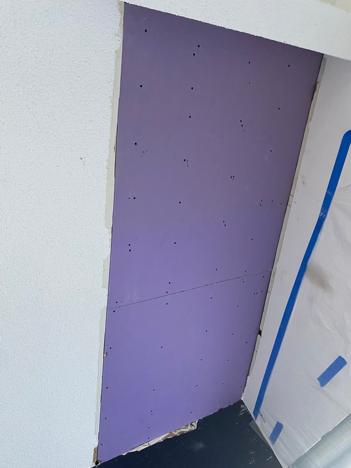Before: new drywall panel installed, seams unfinished